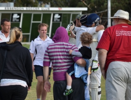 Hugs all around: Moonee Valley players and spectators rush the field. L-R Shaun Rayment and Alex Gorham look on, as Murray Walker engages in a group hug with batsmen Jesse Felle and Pat Taylor. Michael Felle (right) also moves in.