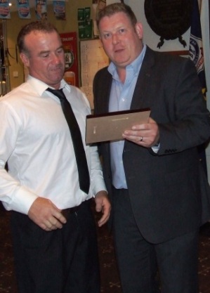 Sean O'Kane (left) admires his Lindsay Jones plaque as VP Simon Thornton reads the citation.