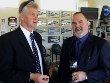 Coach Rex Bennett (left) talks with past player Brian O'Reilly.