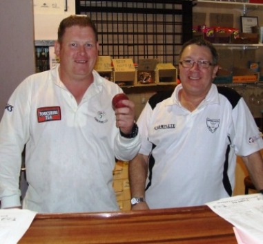 Simon Thornton (left) celebrates his 100th wicket for the club - achieved in his 50th game - with fellow committee member Peter Golding.