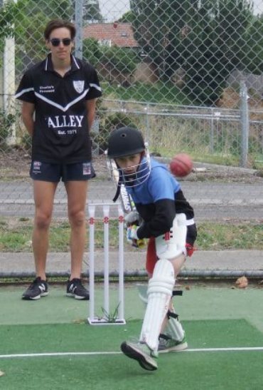 Leo Zabarauskas faces the bowling machine, watched by Firsts player Anthony Cafari. 