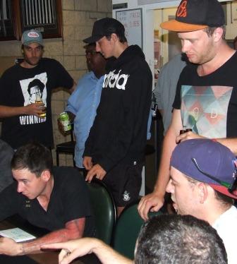 Down to the business end: Poker night boss Cav deals out the cards, watched by (from left) Jesse Felle, Channa DeSilva, Stephen Esmore, Justin Trowell and Matt Thomas.