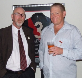 How it must hurt Darren Nagle (right) to stand in front of an Essendon jumper. But there's no problem for Kevin Gardiner.