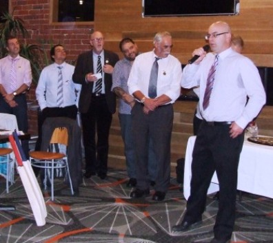 The man of the moment speaks: Michael Cumbo takes the microphone to respond after receiving his Life Membership, flanked by Life Members (L-R) Jim Polonidis, Danny Terzini, Kevin Gardiner, Sandro Capocchi and Charlie Walker.