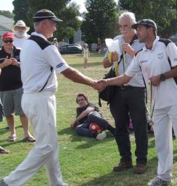 Rex Bennett steps forward to receive his medal from skipper Jim Polonidis, while president Charlie Walker hands over the silverware.