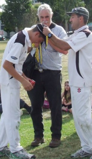 Our young gun: Jack Newman receives his Premiership medal from captain Jim Polonidis, while President Charlie Walker looks on.