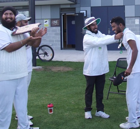 Jaykumar Patel receives his Man of the Match medallion from umpire Mehedi Hasan.