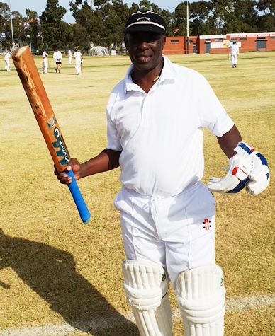 Coach Mark Grenville celebrates his unbeaten century.