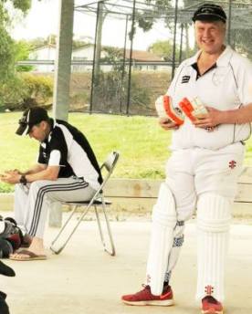 Pete Smith readies himself to take on the bowlers, while the day's skipper, Jim Polonidis offers wise words of encouragement.