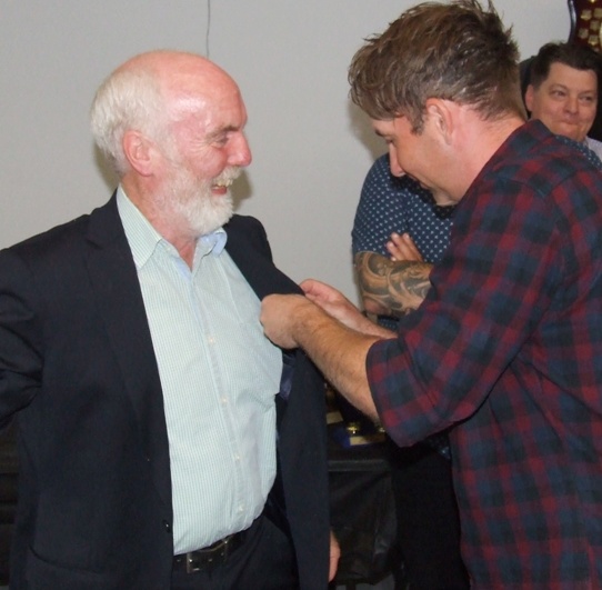 One Life Member to another - Ben Thomas pins Allan Cumming's badge to his lapel.