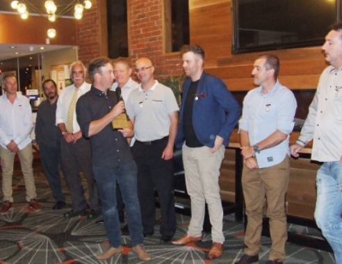 The Life Members gather as new inductee Ben Thomas turns to acknowledge the honor, presented to him by his brother Matt.