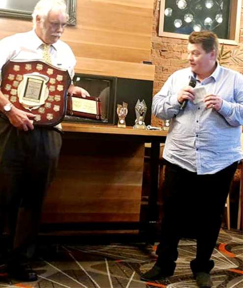 Mark Gauci responds to the announcement of his Lindsay Jones Award, while President Charlie Walker holds his plaque and the perpetual trophy.