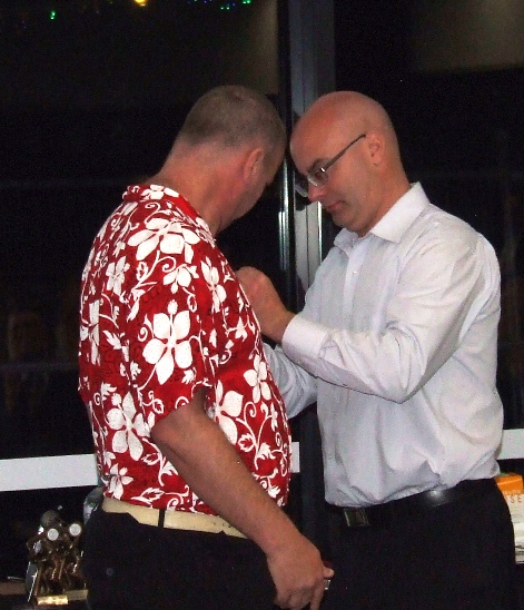 Life Member Michael Cumbo pins on the medallion for new Life Member Shaun Rayment.