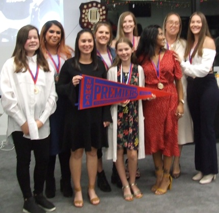 Our women's team receive their Premiership flag. L-R: Audrey Brown, Tanya Intagliata, Yasmin King, Sarah Ronayne, Katherine Baker, Kelsie Armstrong, Jane Raman, Sarah Gooden and Tara Newman.