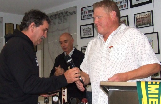 Tony Gleeson is handed the microphone by Darren Nagle after being inducted as a Life Member, with John Talone behind.
