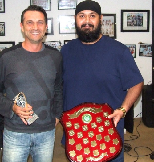 Jason Ripa receives his Fourths batting award from captain Manu Singh (far right), holding the Premiership shield.
