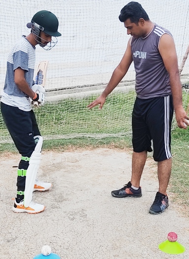 International player/coaching panel member Wasim Abbas teaching one of his junior Pakistan players.