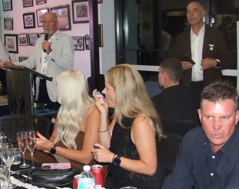 The Denny family table: L-R daughters Amy Denny and Alicia Stanton with her husband Danny; with Greg Peters and John Talone on the stage.