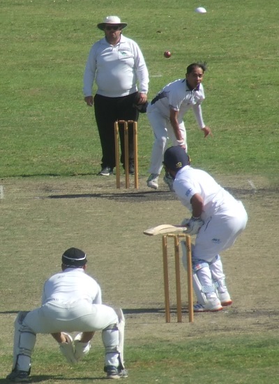 Prashant Hirani bowling in his 50th match, with Chand Shrestha keeping.
