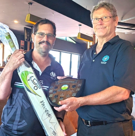 Moonee Valley's Brendan "Jonty" Rhodes (left) receives the Barooga trophy and a signed bat from organiser Tony Tranter.