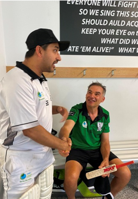 A few well-chosen words from skipper Sunny Sharma, as Dean Jukic gets a memento of the 300th game.