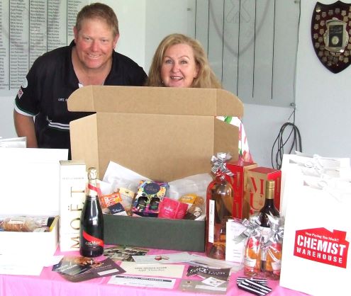 Darren Nagle and Jenny O'Brien show off some of the prizes donated to the raffles.