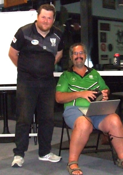Master of Ceremonies and vote announcer Brendan "Jonty" Rhodes with his trusty computer, and with penciller Andreas Skiotis.