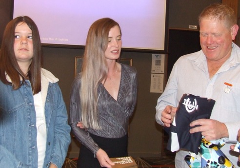 Women's team members Audrey Brown (left) and Kelsie Armstrong were part of a presentation to their co-coach Darren Nagle.