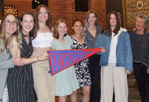 Members of our women's team and their premiership flag: L-R Sarah Gooden, Sarah Fenn, Tara Newman, Katherine Baker, Yasmin King, Kelsie Armstrong, Audrey Brown and Adele Walker.