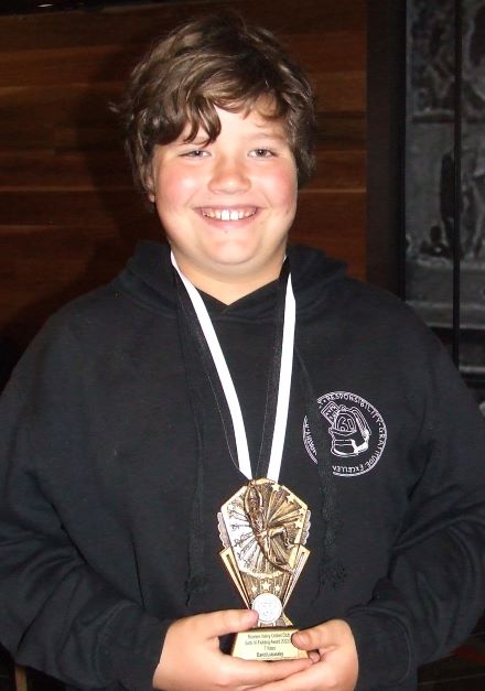 Young gun David Lubansky with his awards for the Sixths - the MVP medal and his fielding trophy.