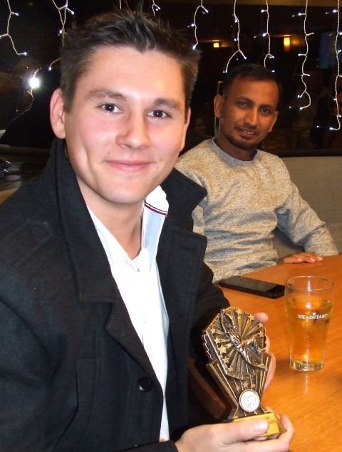 First Eleven captain Jack Newman with his fielding award - and teammate Salman Afridi in the background.