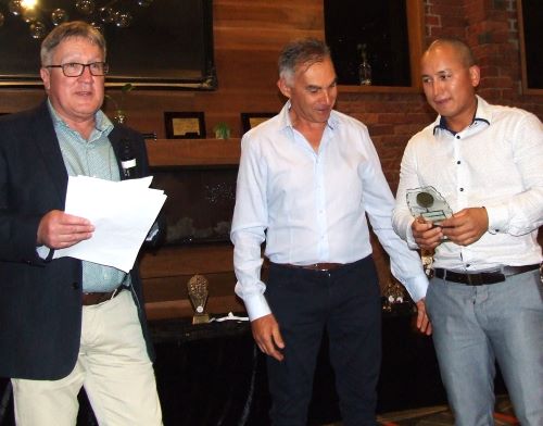 Chand Shrestha (right) is awarded the Sean O'Kane Trophy by Peter Golding (left) and Dean Jukic.