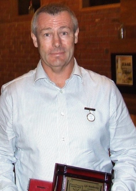 Geoff McKeown with his Life Member badge and plaque.