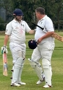 Geoff Smith (right) gives some advice to son Lachlan as he goes in to bat.