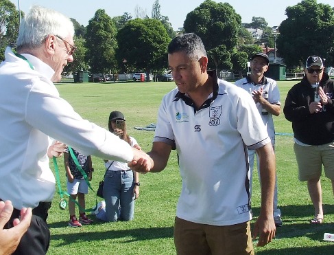 Spin king Sunil Bhandari receives his Man of the Match medallion from umpire Graham Slater.