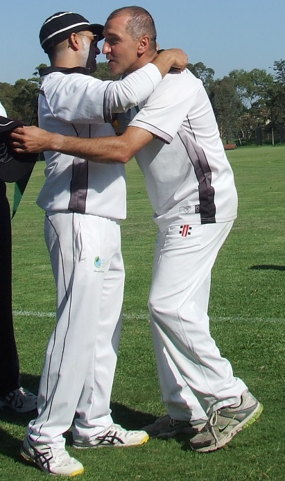 Jim Polonidis (right) gets a hug - and a premiership medallion - from skipper Sunny Sharma.