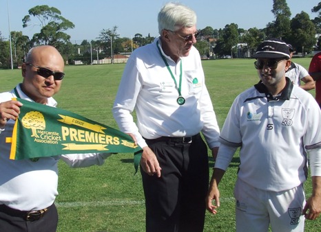 Captain Sunny Sharma with umpires Wilson Chan (left) and Graham Slater.
