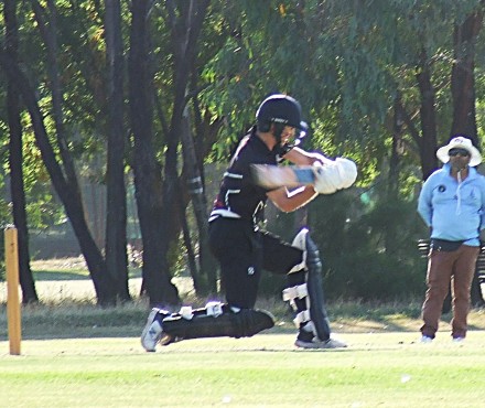 Dejan Gilevski hits out, watched by umpire Tarek Patel.