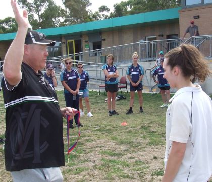 High five, keeper! Coach Darren Nagle presents Sarah Fenn with her premiership medal.