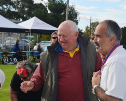 Our Joey! Joe Ansaldo seems emotional as he receives his premiership medal from Ralph Barron.