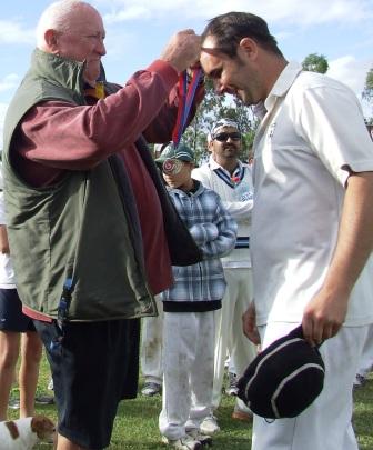 Five-wicket hero Murray Walker receives his Premiership medal from Pascoe Vale Central stalwart Ralph Barron - after whom the grade was named.