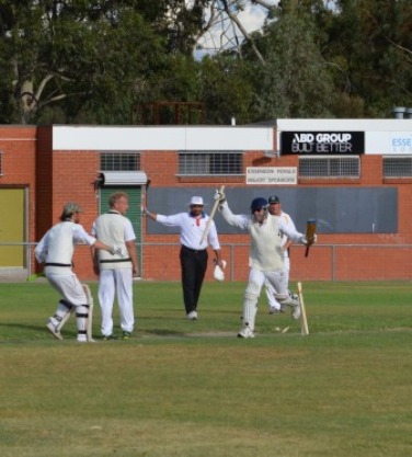 We did it! Jesse Felle (left) runs towards Pat Taylor as the winning four scorches over the boundary line, while umpire Farhan Khan signals match over.