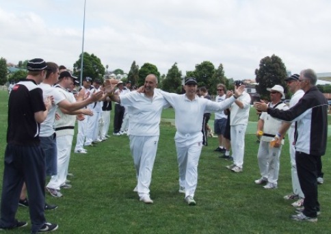 Joe Ansaldo (left) and John Talone enter the field through an honor guard of past and present players for their 300th games.