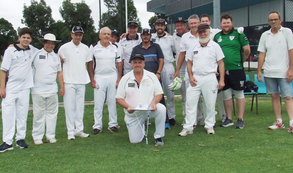 Postcode Peter Smith and his autographed hat in front of teammates and clubmates before the game - L-R: Eden Del Citto, David Lubansky, Minh Vo, Graeme Bloom, Mark Gauci, Mitch Britton, Danny Terzini, Michael Ozbun, Shaun Rayment, Murray Price, Allan Cumming, Jackson Price, Andreas Skiotis and Pat Taylor.